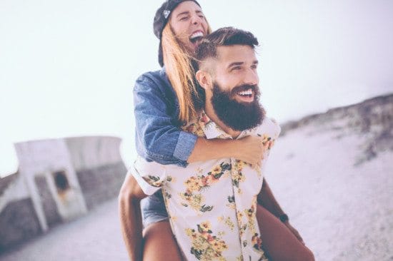 laughing couple riding piggyback