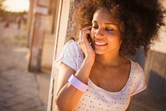 Black woman on cell phone outside