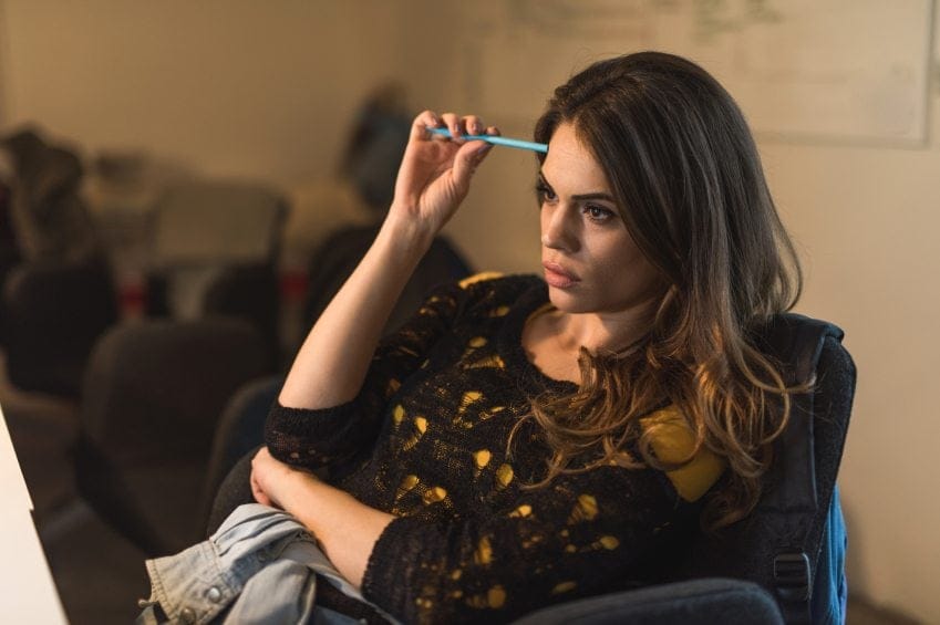 Young woman sitting in the office and thinking.