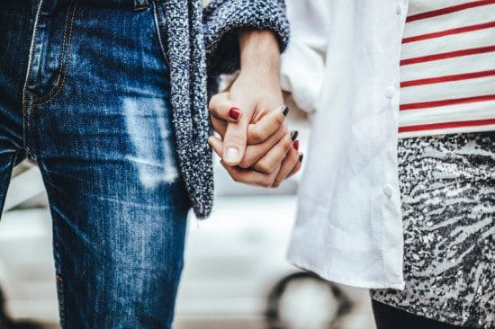 close-up of couple's clasped hands