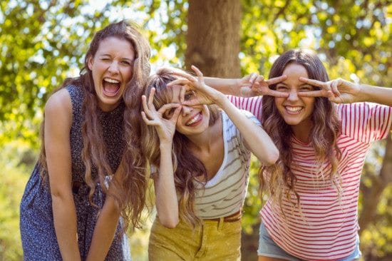 three friends making faces outdoors