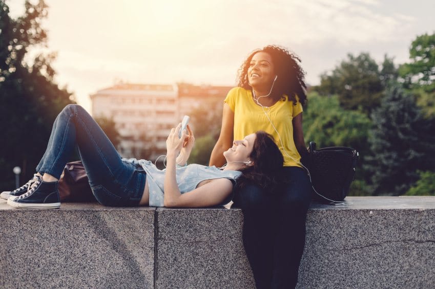 best friends chatting outside in sun