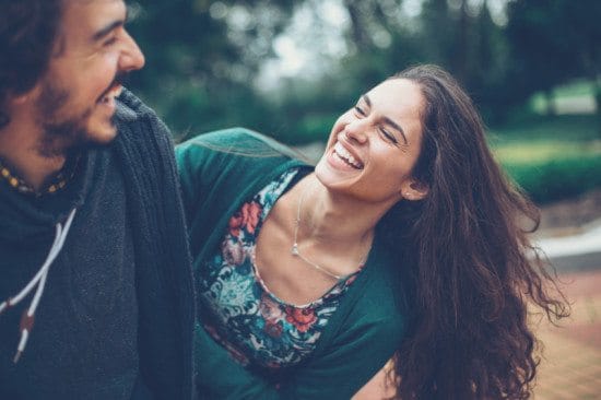 couple laughing and pranking in park