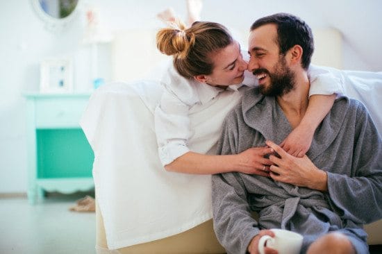 romantic couple hugging in robes
