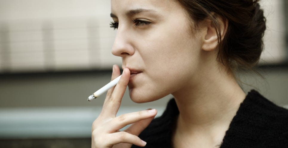 serious woman smoking cigarette