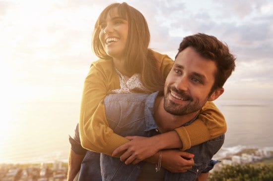 woman riding piggyback on boyfriend