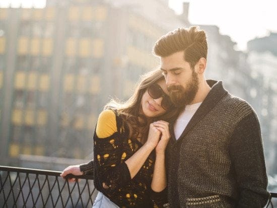 couple cuddling on rooftop