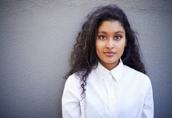serious indian woman against wall