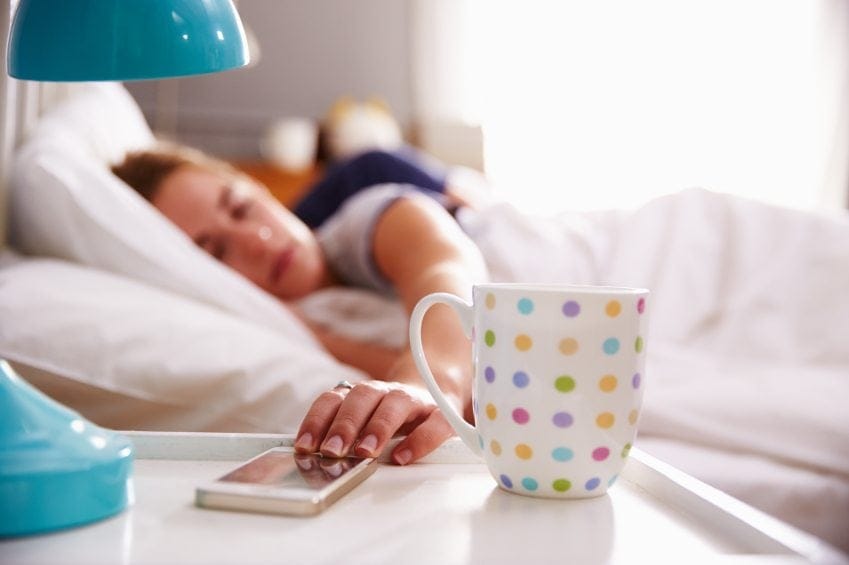 woman waking up to her phone ringing