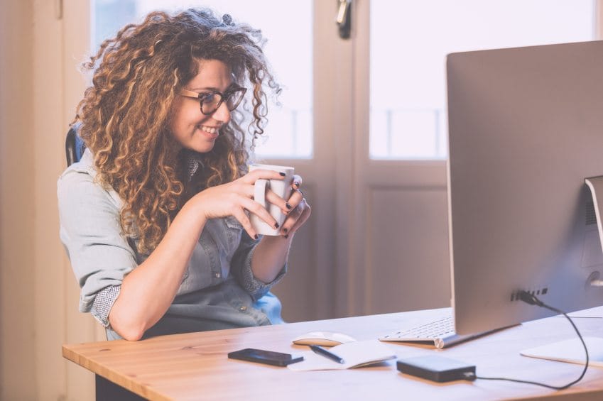 Happy woman working on her computer.