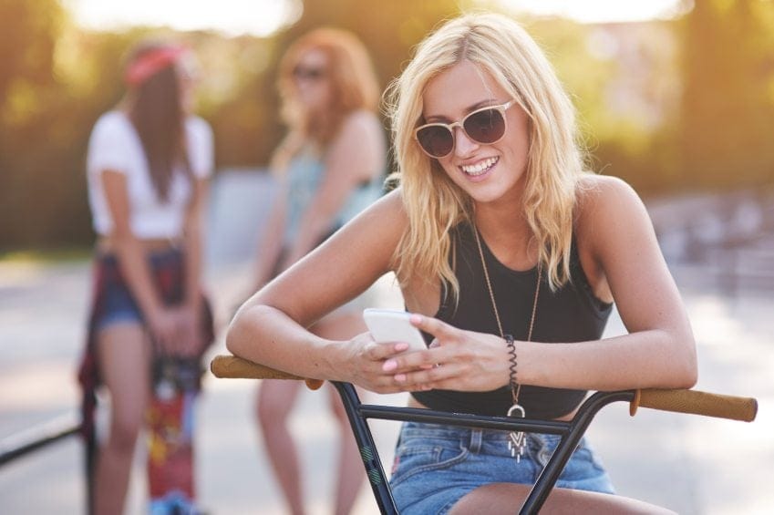 girl texting bike summer sun