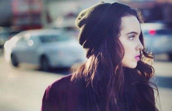 woman in beanie looking to side