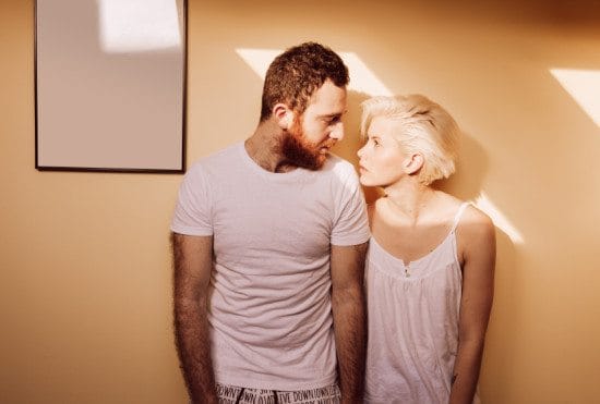 half-asleep couple staring at each other