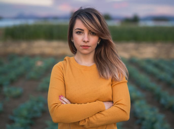 brunette woman long hair orange sweater
