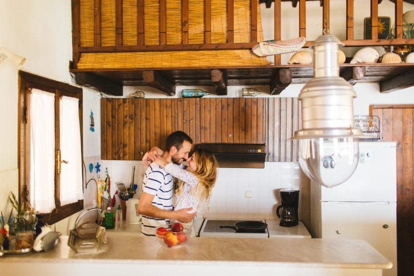 couple kissing kitchen house