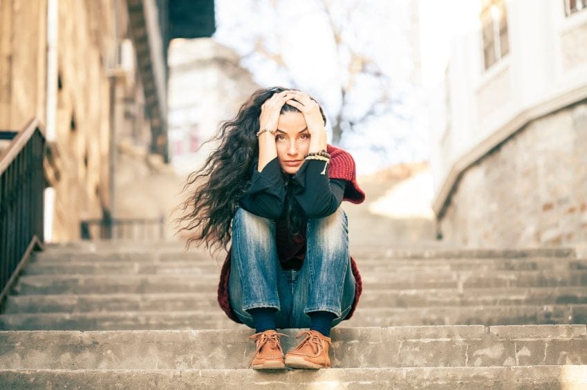 Young woman sat on steps
