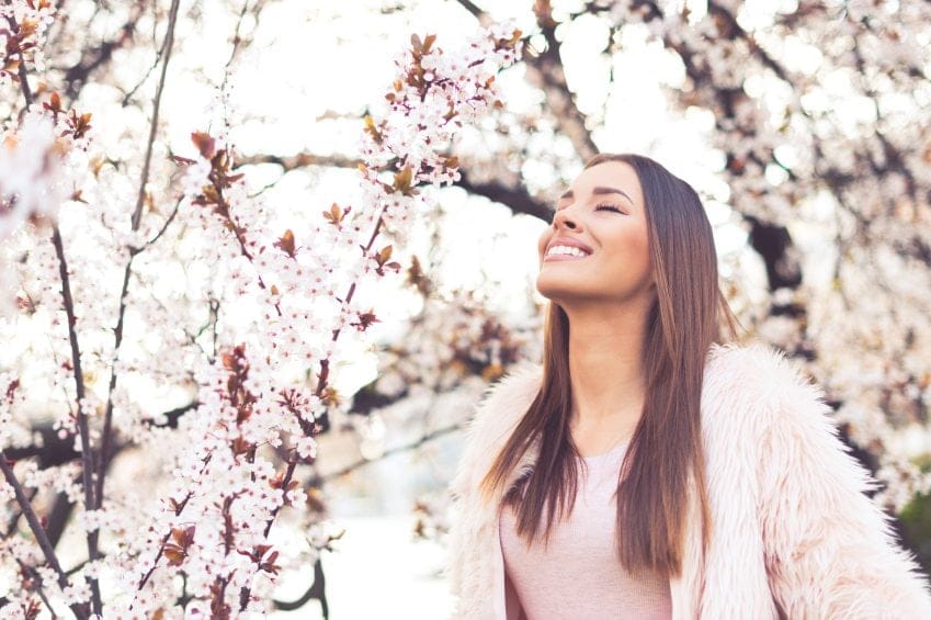 woman happy cherry blossoms