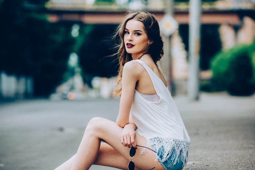 beautiful girl posing in the city on the street
