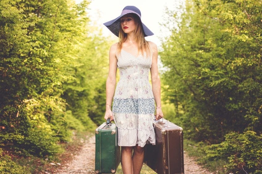 Young woman carrying her luggage.