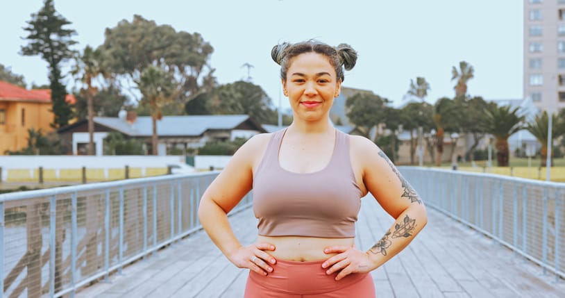 woman smiling outside hands on hips