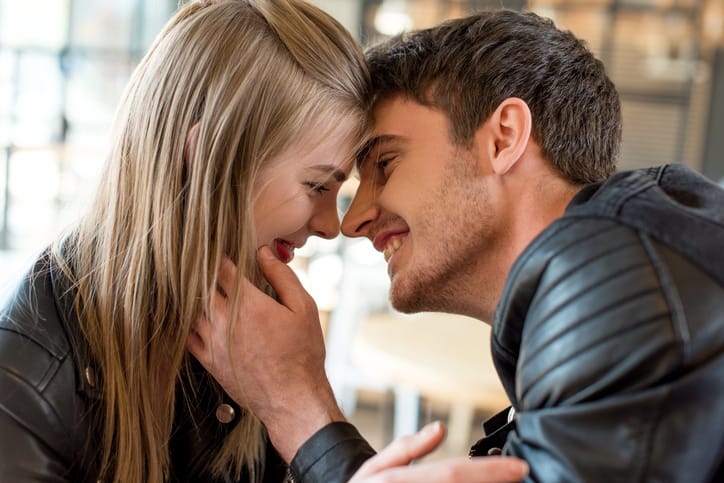 side view of young man kissing beautiful girlfriend