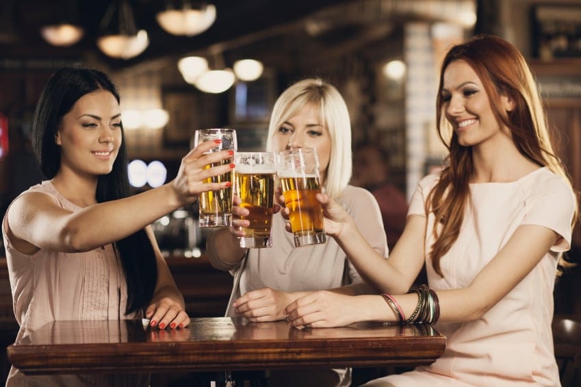 Three women cheers to celebrate.