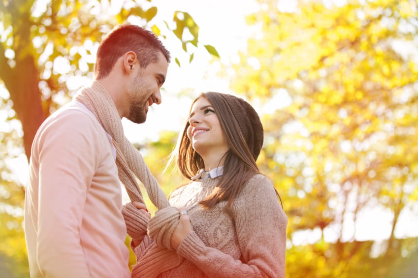 couple about to kiss near trees