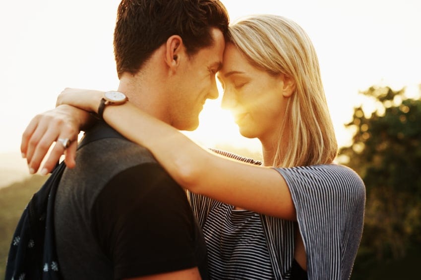 Couple holding each other in sunset