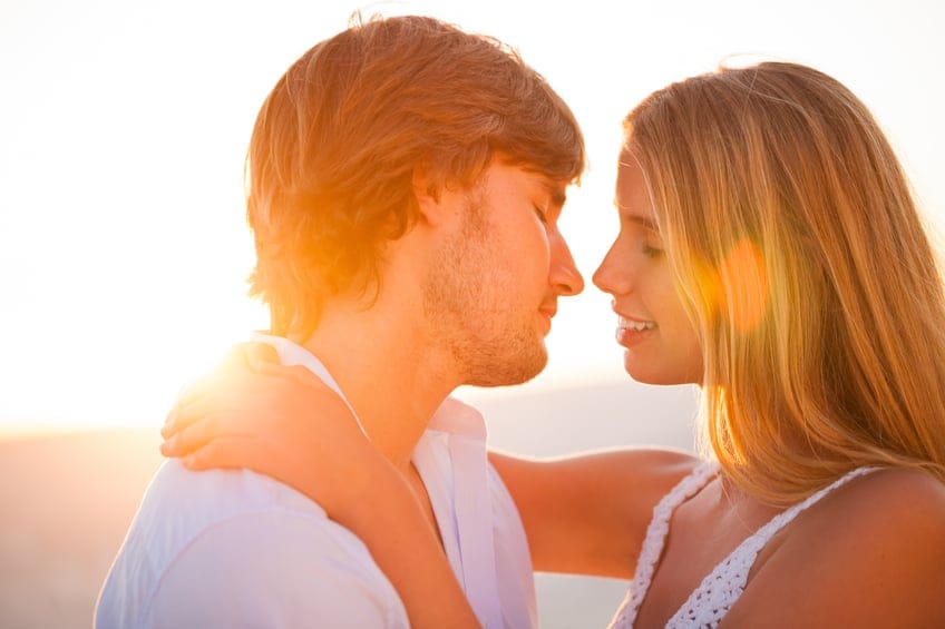 couple kissing sunset
