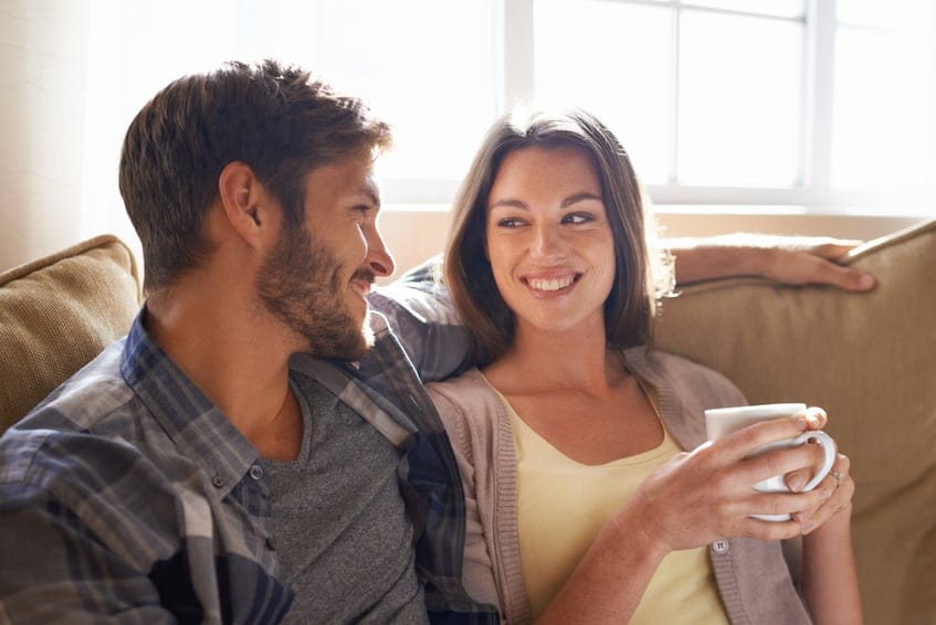 Shot of an affectionate couple drinking coffee at home