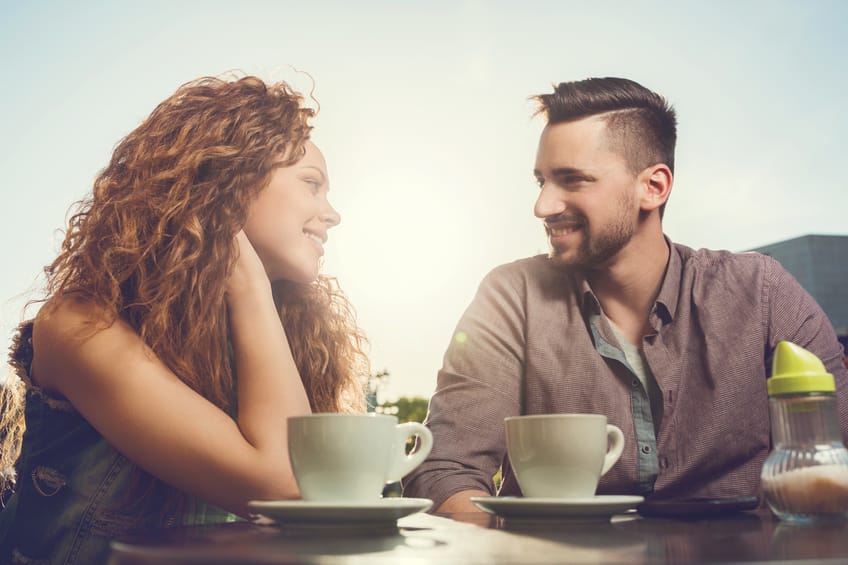 Young couple enjoying a day in a cafe and communicating.