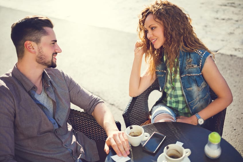 Above view of happy couple talking in a cafe.
