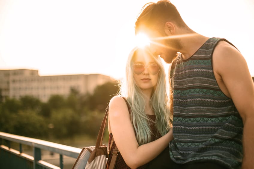 Beautiful and loving teenage couple at the sunset