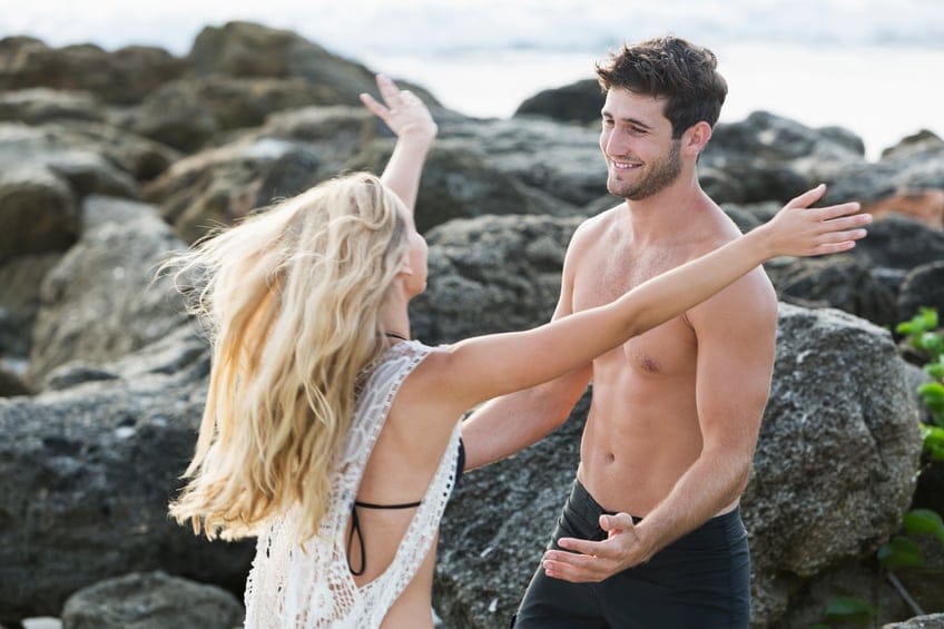 Young couple reaching out to embrace one another
