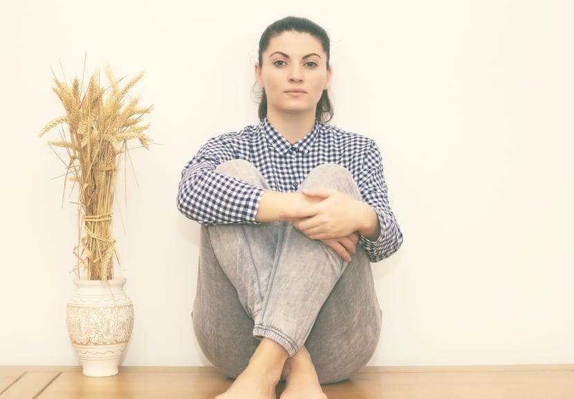 woman wall sitting portrait serious