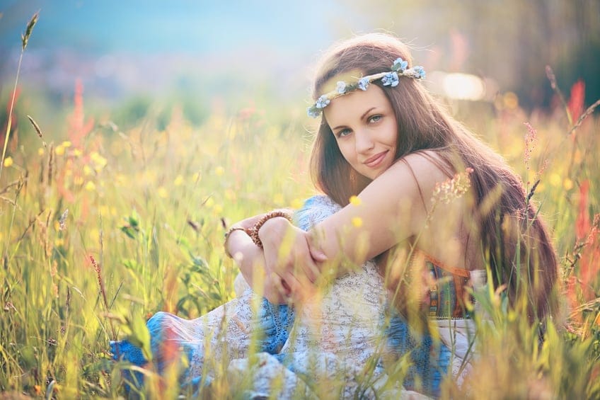Beautiful romantic woman in flower field