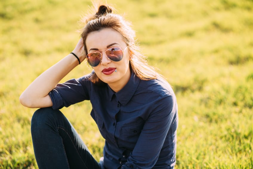 Beautiful woman sitting on the grass.