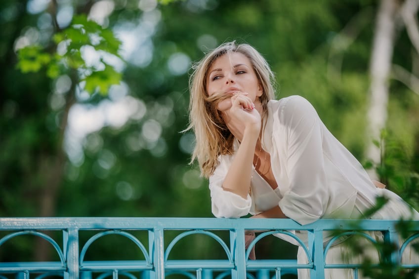 Blonde woman looking over bridge