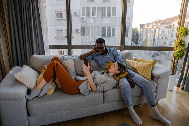 couple hanging out on the couch in apartment