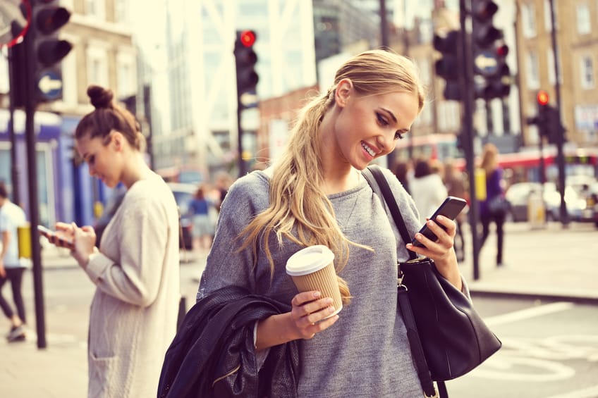 Smiling young woman standing on the street