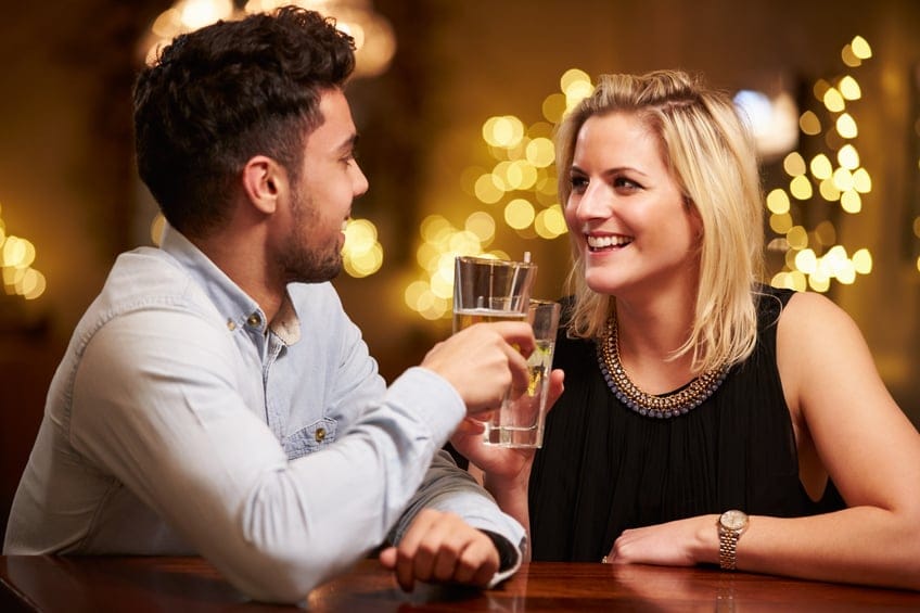 Couple Enjoying Evening Drinks In Bar