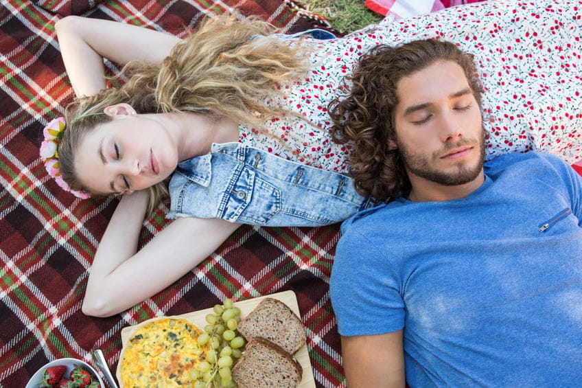 Cute couple having a picnic on a summers day