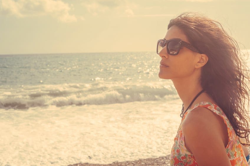 portrait of young beautiful woman with the sea in background