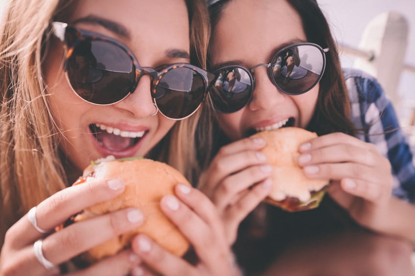 Best friends eating burgers together.