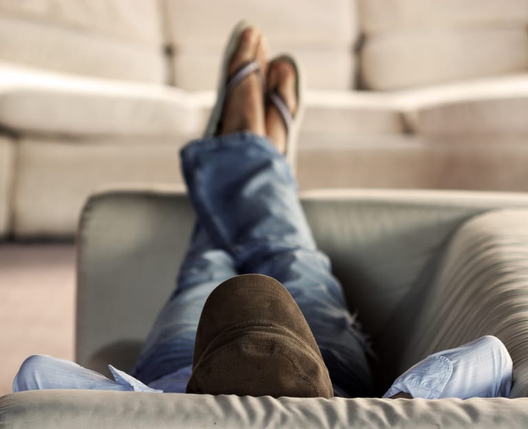 A young man lounging on the couch.