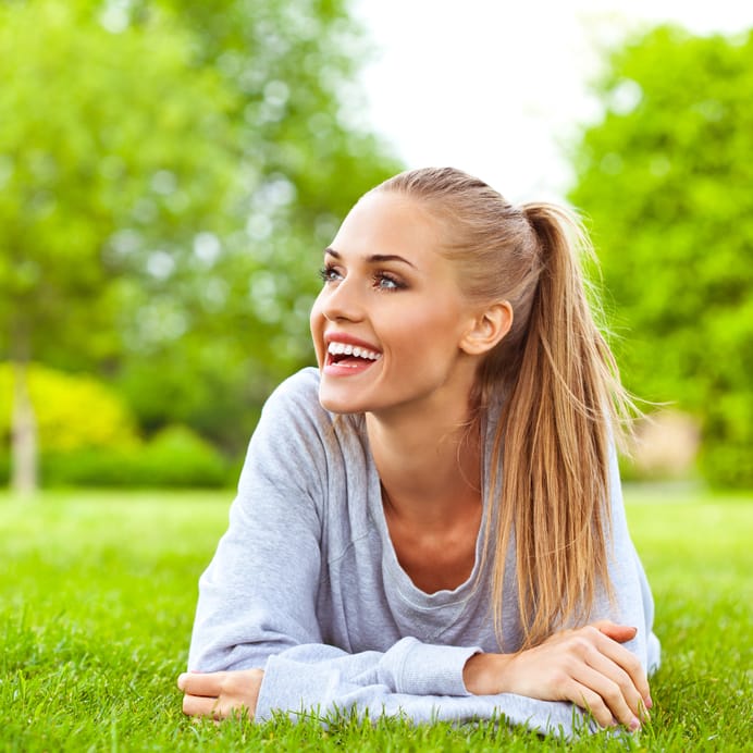 Happy young woman resting a park