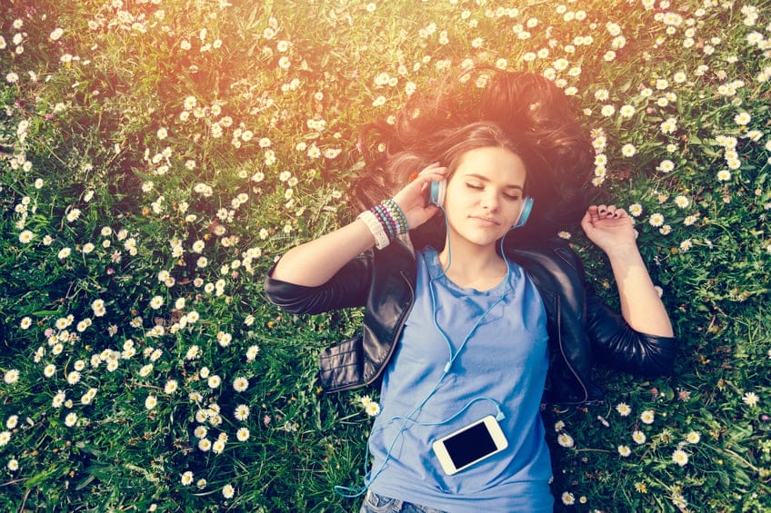 woman grass headphones summer