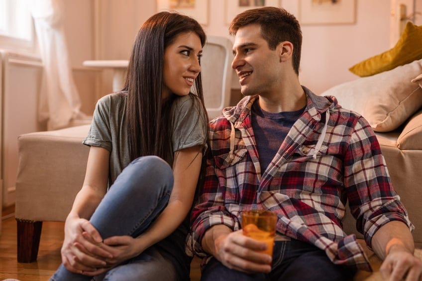 Young loving couple sitting on the floor