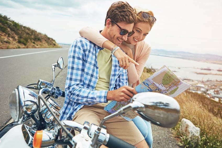 couple close motorcycle seaside mountain highway