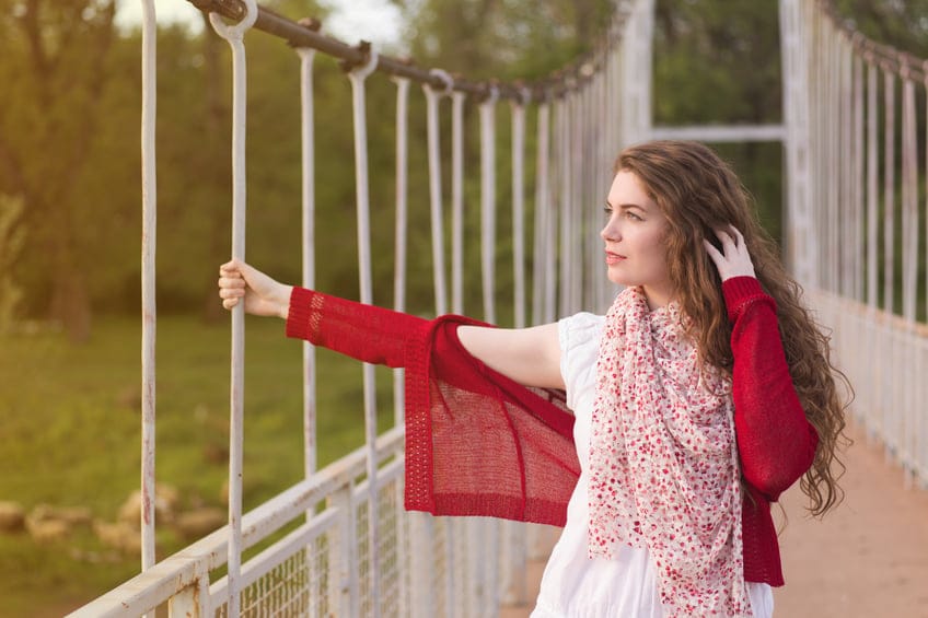 Beautiful young woman posing on the bridge. 'Hand in hair' pose.